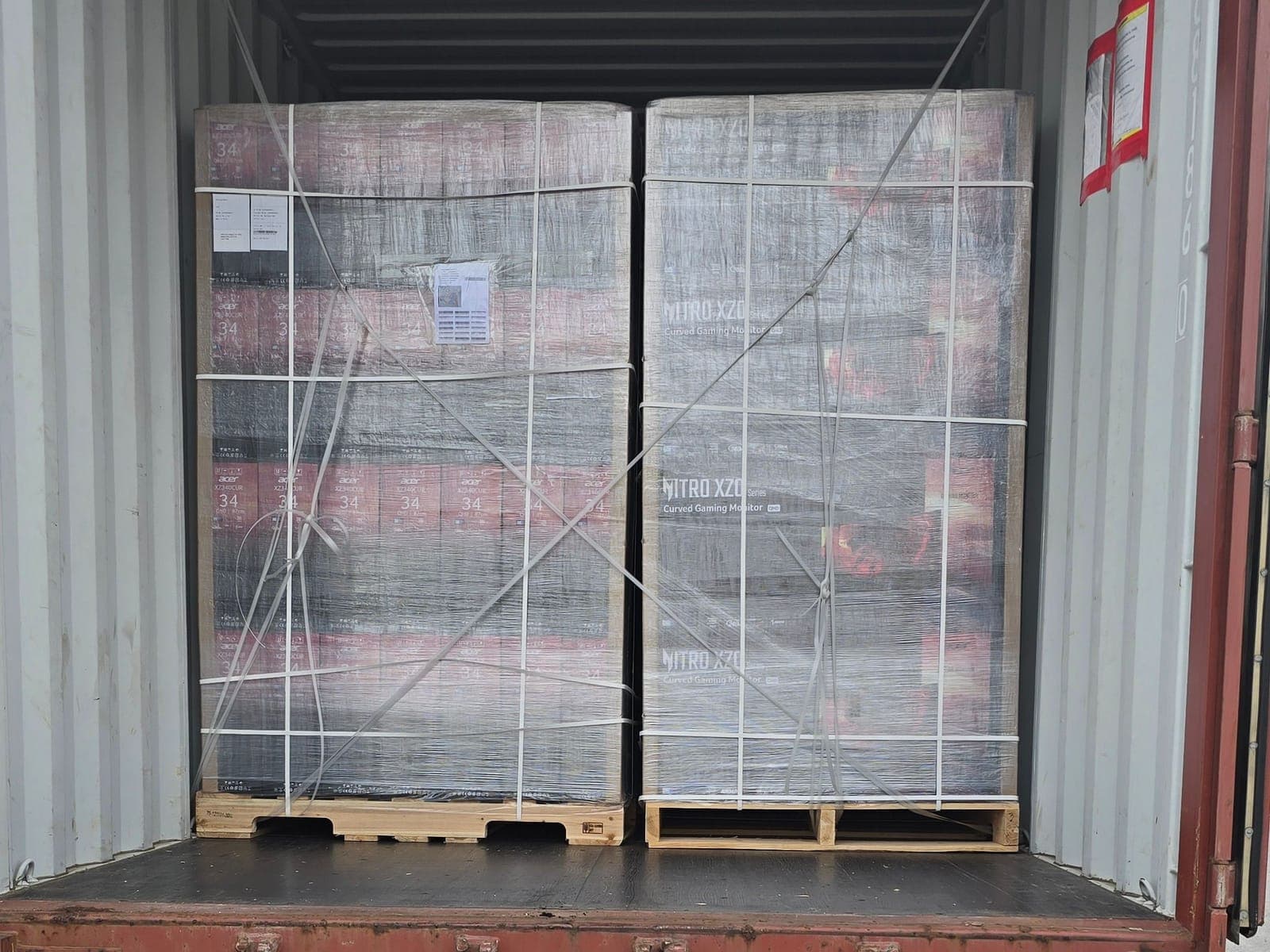 Open container at the dock with stretch-wrapped pallets inside