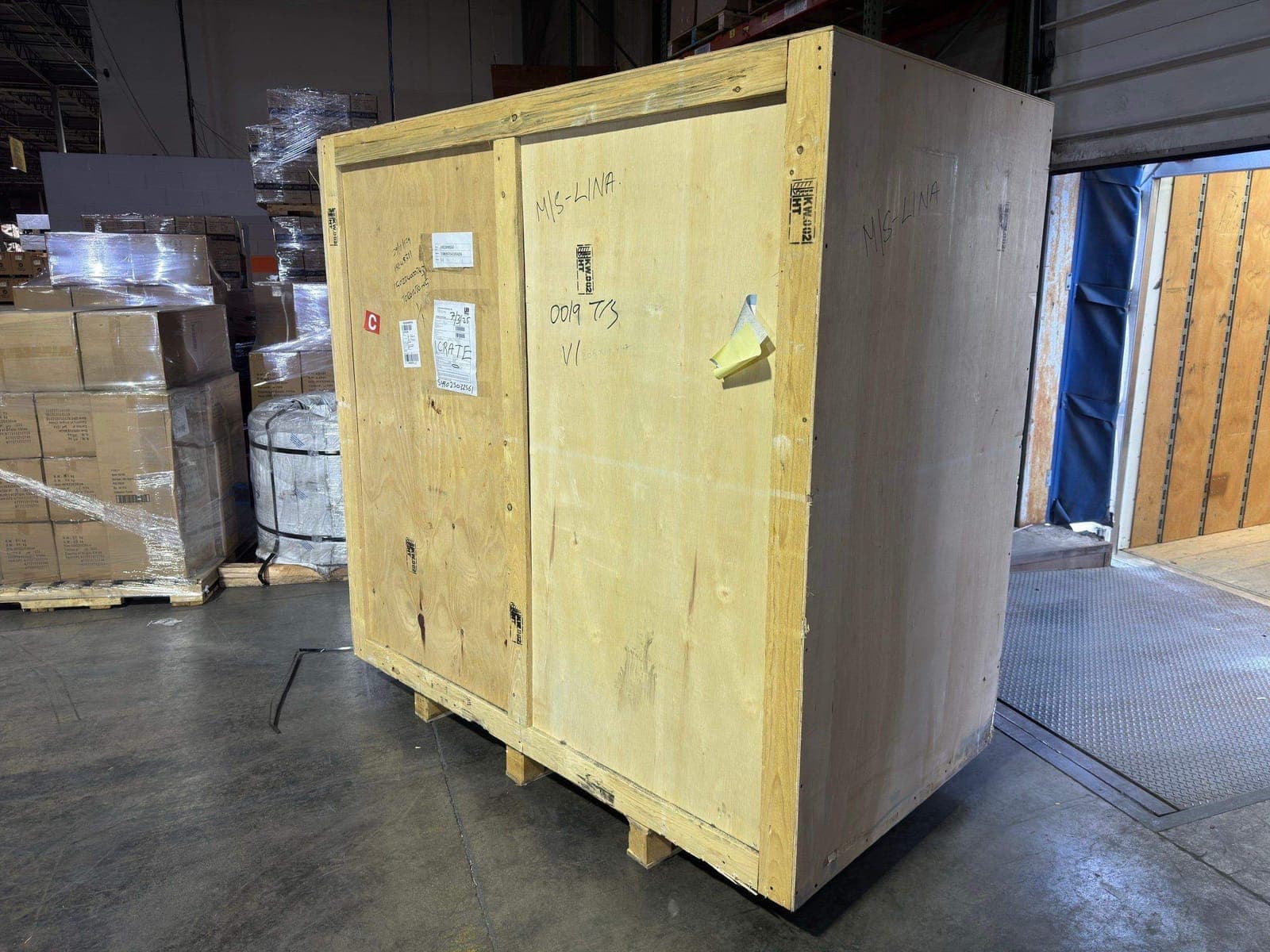 Inside the Metropolitan Logistics North York warehouse — a packed lift van staged at the dock