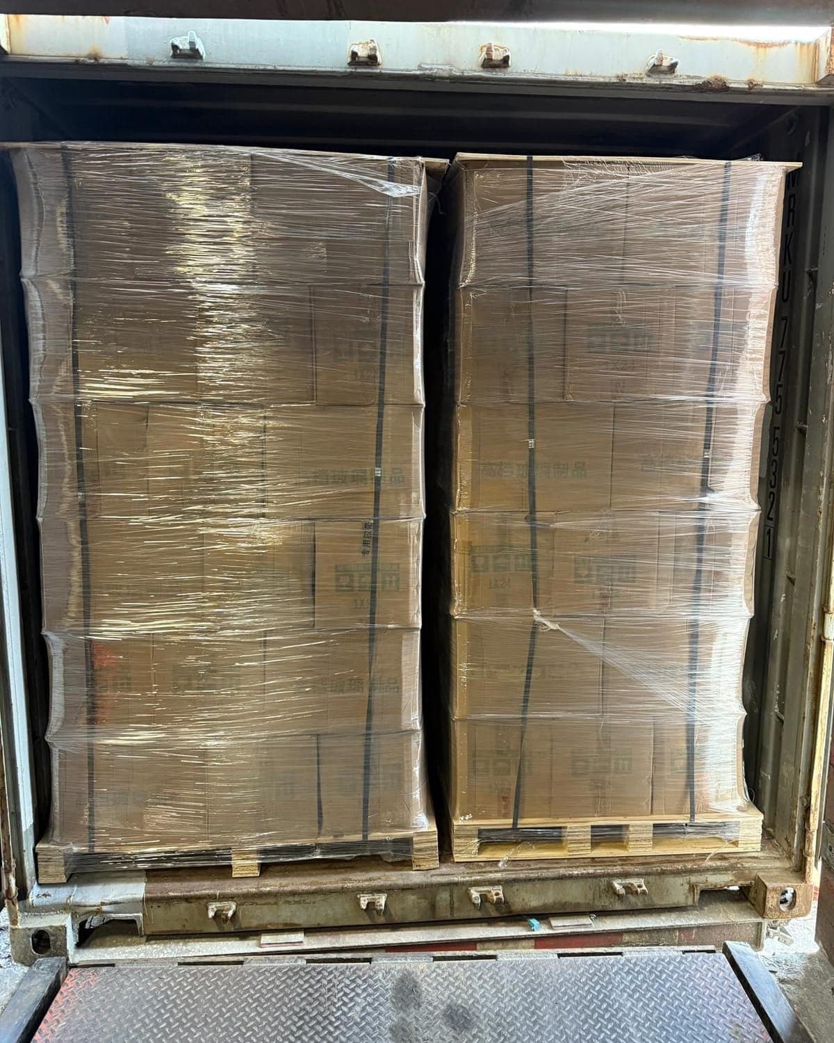 Container freight palletized, wrapped and strapped at the dock